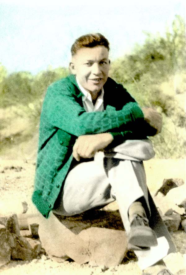 John sitting in a desert setting