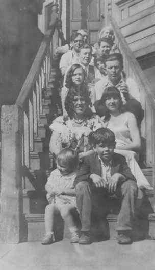Members of the Boyd family sitting in pairs on a set of tall stairs